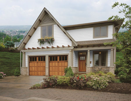 Residential home after upgrade with Clopay Reserve Collection Semi-Custom wood garage doors.