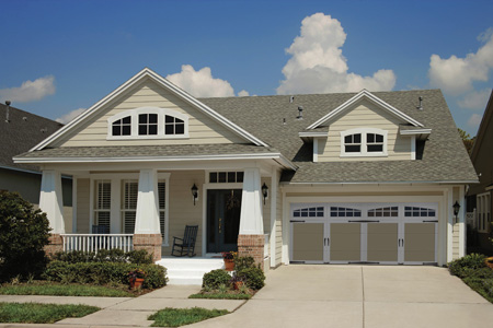 Residential home after upgrade with Clopay Coachman Collection garage doors.